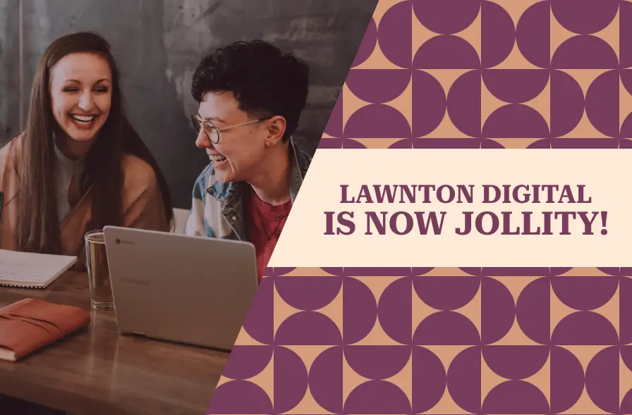 The image features two people, a woman and a man, smiling and collaborating over a laptop. They are seated at a table with notebooks and a cup of coffee. The left side of the image is cut with a geometric design in warm colors, featuring a repeating pattern of circles in purple and beige. On the right, bold text reads, "LAWTON DIGITAL IS NOW JOLLITY!" signaling a brand name change. The overall mood of the image is upbeat and friendly, with a modern, creative atmosphere.