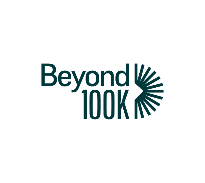 The image is the logo for Beyond100K, a nonprofit organization focused on addressing the STEM teacher shortage. The logo features the text "Beyond100K" with a stylized graphic of rays or sunburst extending from the "K," symbolizing growth, innovation, and forward movement. The design conveys a sense of progress and impact in the field of STEM education.