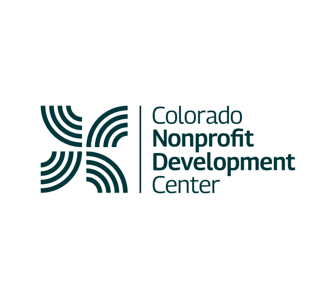 The image shows the logo of the Colorado Nonprofit Development Center (CNDC). The logo features a dynamic, abstract design with curved lines forming a cross-like shape, paired with the organization’s name in a modern, sans-serif typeface. The design emphasizes both movement and connection, symbolizing the organization’s commitment to supporting nonprofit growth and development across Colorado. The color scheme is a deep teal, reinforcing professionalism and trust.